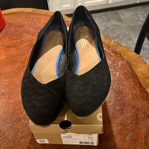 Tom’s black suede chevron embossed flats